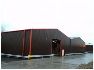 Warehouse unit from a steel shed in brown and red cladding
