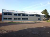 Double height industrial steel building with windowed office space