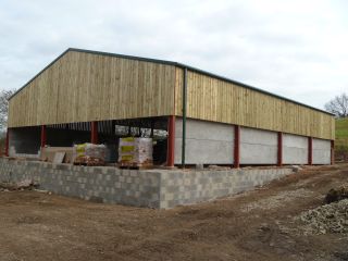 Barn in construction, finished with wooden slat cladding